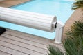 Pool cover rigid on the edge of a pool during the summer Royalty Free Stock Photo