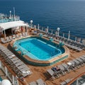 Pool deck on a cruise ship with a central rectangular pool surrounded by a wooden Royalty Free Stock Photo