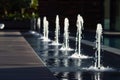 pool deck with minimalist fountains linearly arranged
