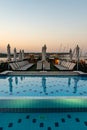 Pool deck and parasols of luxury boat cruise ship in egypt luxor during dawn sunset Royalty Free Stock Photo