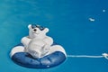 Pool decoration in the form of a relaxed bathing polar bear with sunglasses and a swim ring