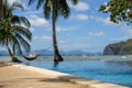 Pool and empty hammock with palm trees, isles and boats on background. Tropical beach. Philippines resort landscape. Royalty Free Stock Photo