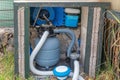 Pool equipment with filtration system and pump in yard for clean swimming water