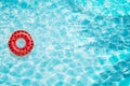 Pool float, ring floating in a refreshing blue swimming pool with palm tree leaf shadows in water Royalty Free Stock Photo