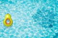 Pool float, ring floating in a refreshing blue swimming pool with palm tree leaf shadows in water Royalty Free Stock Photo