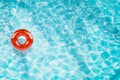 Pool float, ring floating in a refreshing blue swimming pool with palm tree leaf shadows in water Royalty Free Stock Photo
