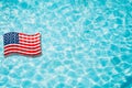 Pool float, ring floating in a refreshing blue swimming pool with palm tree leaf shadows in water Royalty Free Stock Photo