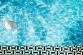 Pool float, ring floating in a refreshing blue swimming pool with palm tree leaf shadows in water Royalty Free Stock Photo
