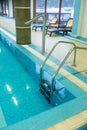 Pool ladder with stairs in empty pool for sport swimming training in leisure center.Ladder stainless handrails for Royalty Free Stock Photo