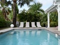 Pool With Lounge Chairs in Tropical Setting Royalty Free Stock Photo