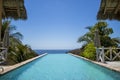 Pool with palms and blue sky in front of mexican beach