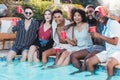 Pool party, beer and friends laughing, having fun and partying. Summer celebration, event and group portrait of people Royalty Free Stock Photo