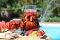Pool party with sangria and cold alcoholic cocktails by the swimming pool Royalty Free Stock Photo