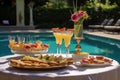 pool party setup with french 75 cocktails in the foreground Royalty Free Stock Photo