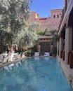 Pool with poolside dining tables inside La Maison Arabe in Marrakesh, Morroco.