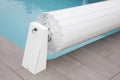 Pool rigid cover rolled up on a roller swiming