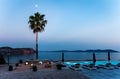 Pool by the sea, moon over a palm tree. Royalty Free Stock Photo