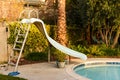 Pool slide and pool in a backyard Royalty Free Stock Photo