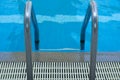 Pool stair on top view on blue water in swimming pool