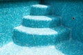 Pool steps in an empty mosaic swimming pool Royalty Free Stock Photo