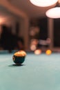 Pool table ball from close perspective blurry