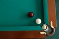 A pool table. Top view. The ball rolls into the pocket. Royalty Free Stock Photo