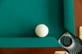 A pool table. Top view. The ball rolls into the pocket. Royalty Free Stock Photo