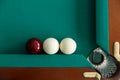 A pool table. Top view. The ball rolls into the pocket. Royalty Free Stock Photo