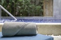 Pool towels are rolled up and placed on a sunbed by the pool in a pool villa in a luxury hotel