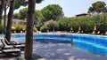 Pool with umbrellas, lounge chairs and red roof villas Royalty Free Stock Photo