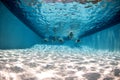 Pool underwater with swimmers