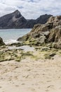 Pool and volcanic rocks on goldenrod sand at Calheta, Porto Santo island Royalty Free Stock Photo