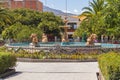 Pool of water accompanied by four small golden statues of peasants, located in the central square of Carhuaz