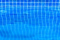 Pool with water edge background. Side front view of swimming pool border close-up. Surface of blue pure water and tile pattern in Royalty Free Stock Photo