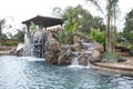 A pool with a waterfall in a luxury backyard Royalty Free Stock Photo