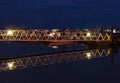 Poole Harbour at night with fishing boats moored on the pontoon, with a walkway to acce