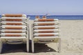 Pooled chaise lounges on the beach Royalty Free Stock Photo