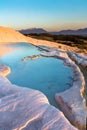 Pools of Pamukkale in Turkey in sunset, contains hot springs and travertines, terraces of carbonate minerals left by the flowing Royalty Free Stock Photo