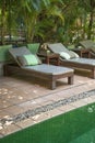 Poolside deck chairs detail in tropical resort