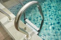 Stainless-Steel Poolside Handrail with Footsteps Royalty Free Stock Photo