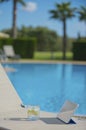 Poolside Lounge Chair With Drink and Tablet Royalty Free Stock Photo