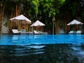 Poolside lounge chairs with large umbrellas Royalty Free Stock Photo