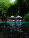 Poolside lounge chairs with large umbrellas Royalty Free Stock Photo