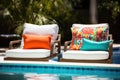 poolside lounge chairs with vibrant cushions Royalty Free Stock Photo