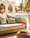 Poolside lounge are with rattan sofa with ornaments pillows. Beautiful hotel spa or wellness concept, recreational vacation resort