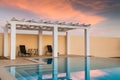 Poolside pergola, gazebo at sunset.