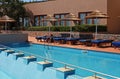 Poolside with pool bed and umbrella Royalty Free Stock Photo