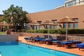 Poolside with pool bed and umbrella in summer resort Royalty Free Stock Photo