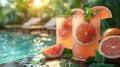 Poolside table with grapefruit mint juice, garnished with mint leaves and grapefruit slices Royalty Free Stock Photo