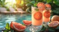 Poolside Table with Grapefruit Mint Juice, Garnished with Mint Leaves and Grapefruit Slices Royalty Free Stock Photo